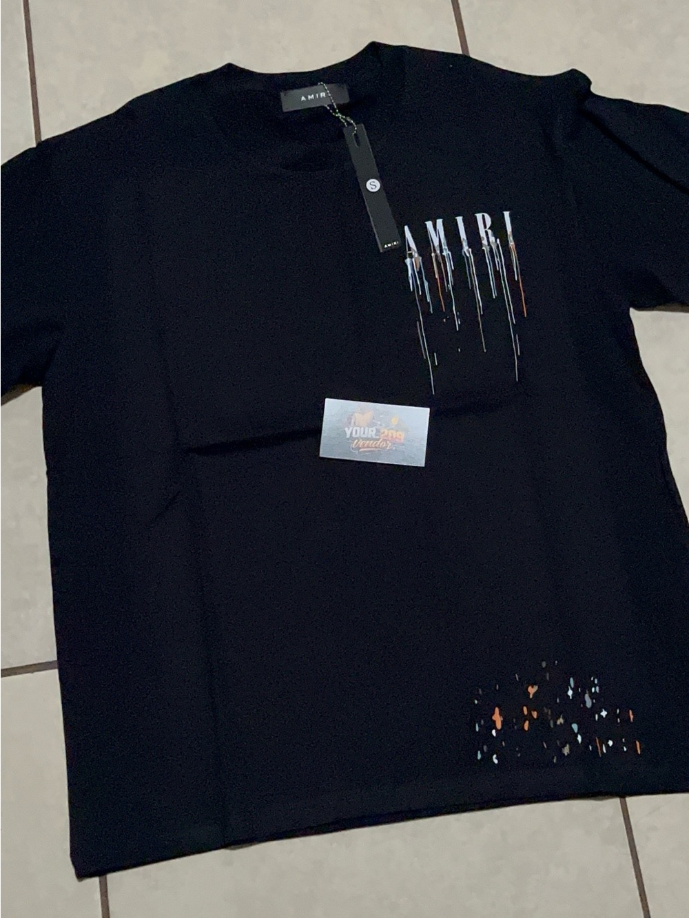 AMIRI Black Tee with White Logo and Multicolor Drip Accents